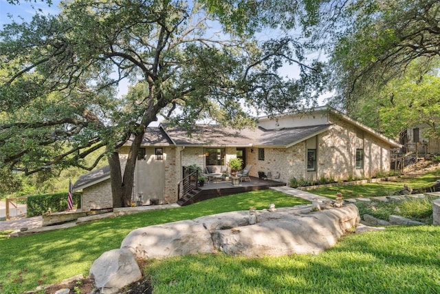 8900 Rockcrest Dr, Austin, TX 78759 - view of front of property featuring a front lawn, a patio area, and brick siding