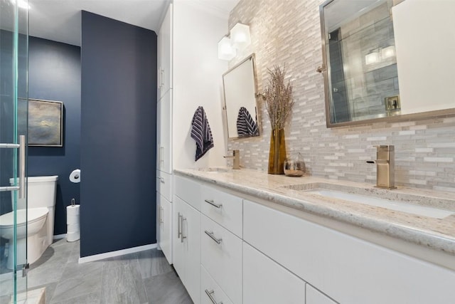 8900 Rockcrest Dr, Austin, TX 78759 - full bath with toilet, tasteful backsplash, double vanity, and a shower with shower door