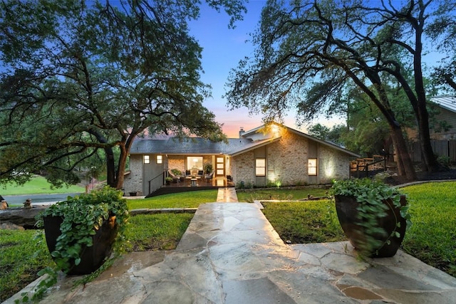 8900 Rockcrest Dr, Austin, TX 78759 - mid-century inspired home featuring a front lawn, brick siding, and covered porch