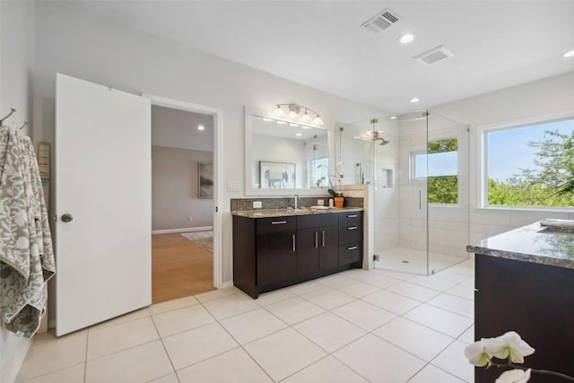 8900 Rockcrest Dr, Austin, TX 78759 - bathroom with vanity, a stall shower, tile patterned floors, and recessed lighting