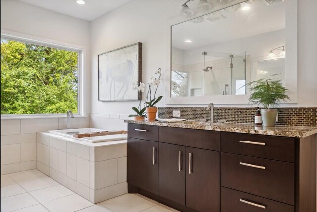 8900 Rockcrest Dr, Austin, TX 78759 - full bath featuring vanity, a shower stall, a garden tub, and tile patterned flooring