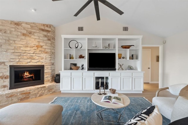 8900 Rockcrest Dr, Austin, TX 78759 - living area with a fireplace, a ceiling fan, vaulted ceiling, and light wood-style floors