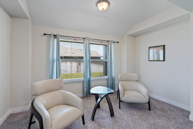 sitting room featuring carpet, lofted ceiling, and baseboards