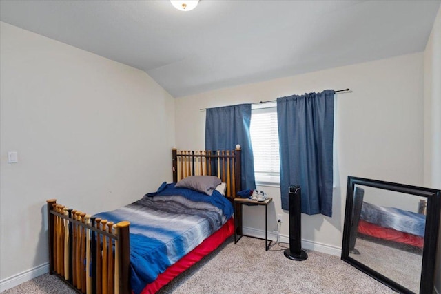 bedroom with carpet flooring, lofted ceiling, and baseboards