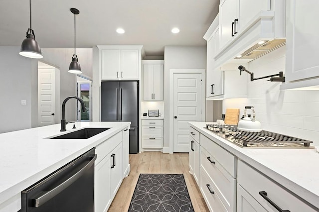 16708 Rakesh Way, Manor, TX 78653 - kitchen with a sink, stainless steel appliances, light countertops, light wood-type flooring, and backsplash