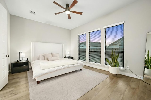 bedroom featuring light wood-type flooring and ceiling fan