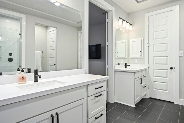 bathroom featuring a stall shower, tile patterned floors, and two vanities