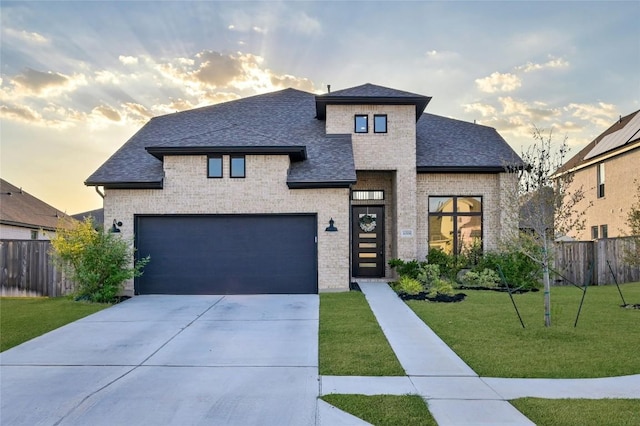 16708 Rakesh Way, Manor, TX 78653 - view of front of house featuring brick siding, a shingled roof, driveway, and a garage