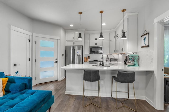5308 Evans Ave Unit 2, Austin, TX 78751 - kitchen featuring stainless steel appliances, a sink, a peninsula, tasteful backsplash, and light countertops