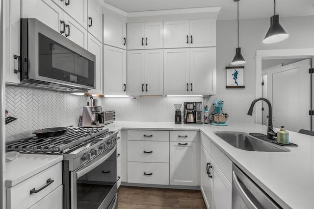 5308 Evans Ave Unit 2, Austin, TX 78751 - kitchen with appliances with stainless steel finishes, a sink, light countertops, and backsplash