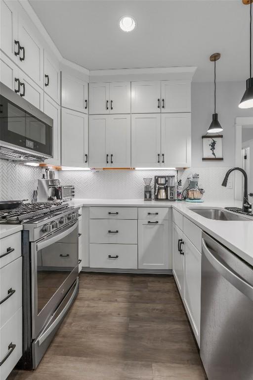 5308 Evans Ave Unit 2, Austin, TX 78751 - kitchen featuring stainless steel appliances, a sink, decorative backsplash, light countertops, and white cabinetry