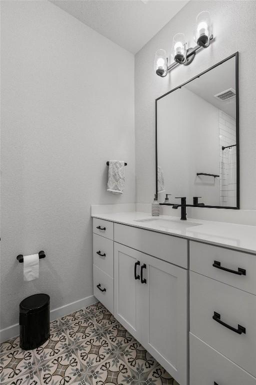 5308 Evans Ave Unit 2, Austin, TX 78751 - bathroom with vanity, baseboards, and tile patterned floors
