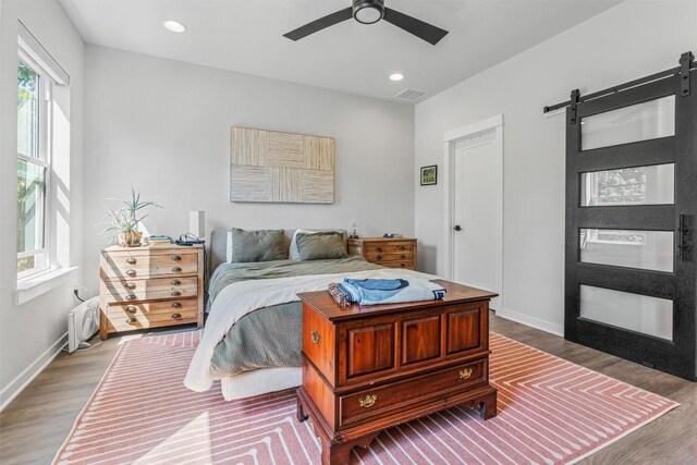 5308 Evans Ave Unit 2, Austin, TX 78751 - bedroom featuring wood finished floors, a barn door, baseboards, recessed lighting, and ceiling fan