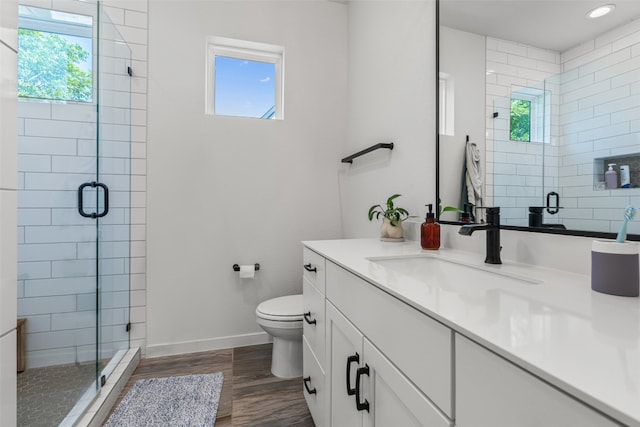 5308 Evans Ave Unit 2, Austin, TX 78751 - bathroom with vanity, toilet, a stall shower, wood finished floors, and baseboards