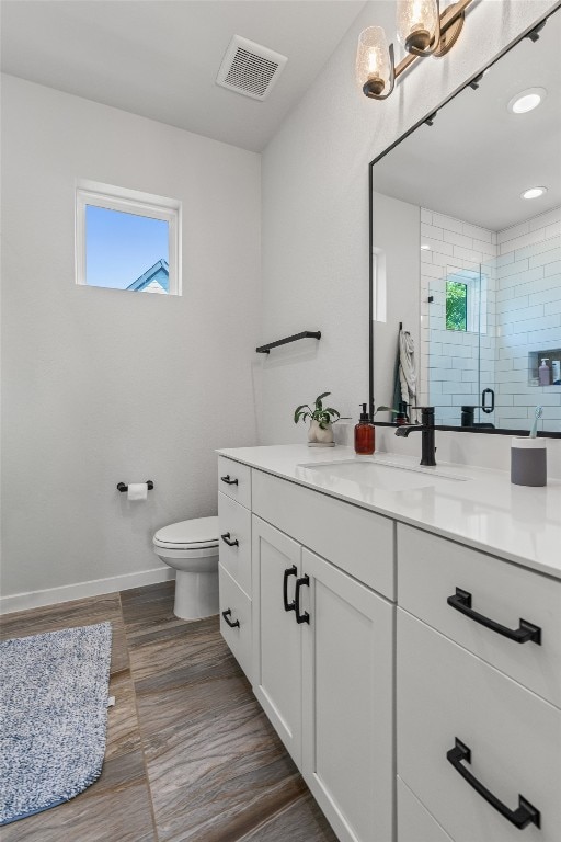 5308 Evans Ave Unit 2, Austin, TX 78751 - full bathroom featuring vanity, toilet, wood finished floors, baseboards, and an enclosed shower