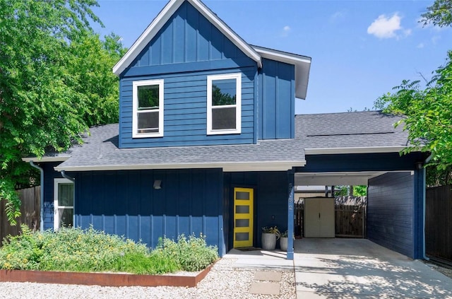 5308 Evans Ave Unit 2, Austin, TX 78751 - view of front of house with a shingled roof, board and batten siding, and concrete driveway
