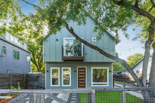 906 Linden St Unit A, Austin, TX 78702 - rear view of house featuring a balcony, a fenced front yard, and board and batten siding