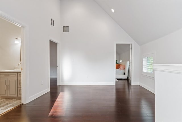 906 Linden St Unit A, Austin, TX 78702 - unfurnished living room with high vaulted ceiling, wood finished floors, baseboards, and a sink