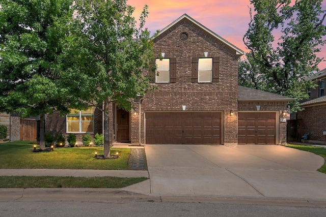 1116 Brenham Ln, Leander, TX 78641 - traditional home with brick siding, driveway, a front yard, and an attached garage