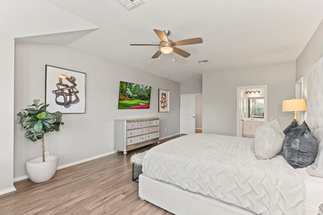 1116 Brenham Ln, Leander, TX 78641 - bedroom featuring wood finished floors, baseboards, ensuite bathroom, and ceiling fan