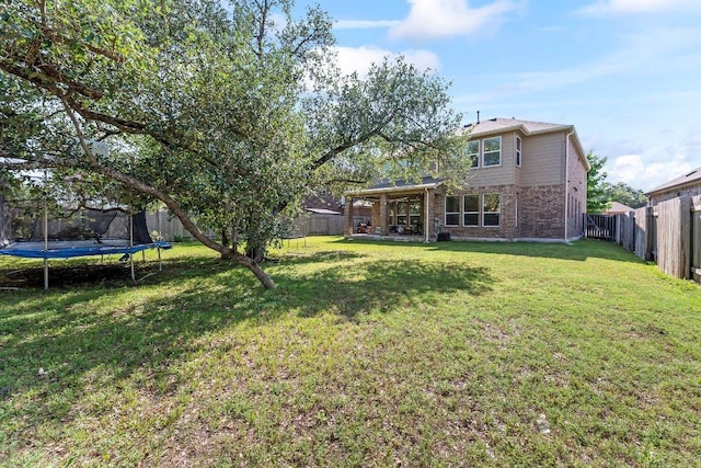 1116 Brenham Ln, Leander, TX 78641 - rear view of property with a trampoline and brick siding