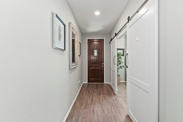 1116 Brenham Ln, Leander, TX 78641 - doorway to outside featuring wood finished floors, a barn door, and recessed lighting