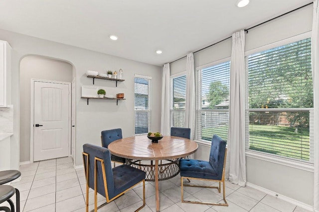 1116 Brenham Ln, Leander, TX 78641 - dining space featuring baseboards, light tile patterned flooring, recessed lighting, and arched walkways