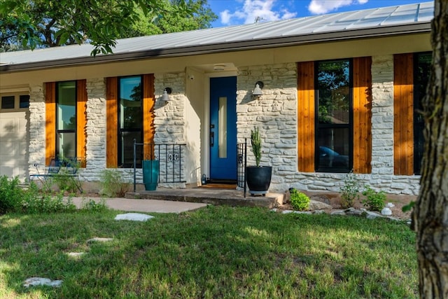 6905 Whispering Oaks Dr, Austin, TX 78745 - view of exterior entry featuring stone siding, a porch, and a standing seam roof