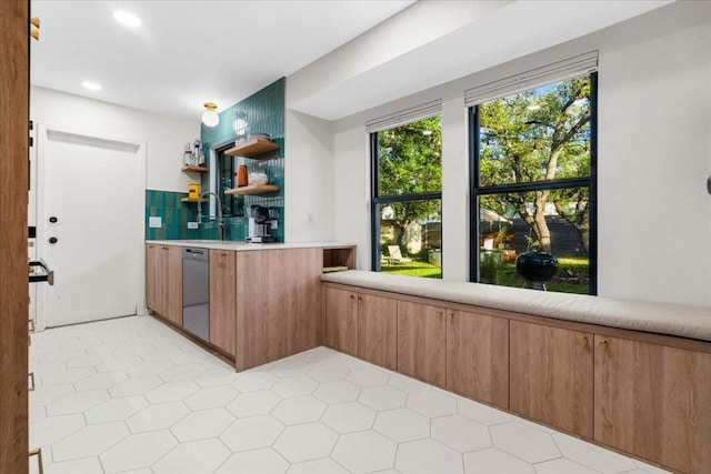 6905 Whispering Oaks Dr, Austin, TX 78745 - kitchen featuring dishwasher, open shelves, light countertops, recessed lighting, and brown cabinetry