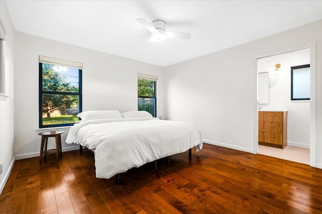 6905 Whispering Oaks Dr, Austin, TX 78745 - bedroom with wood-type flooring, baseboards, connected bathroom, and ceiling fan