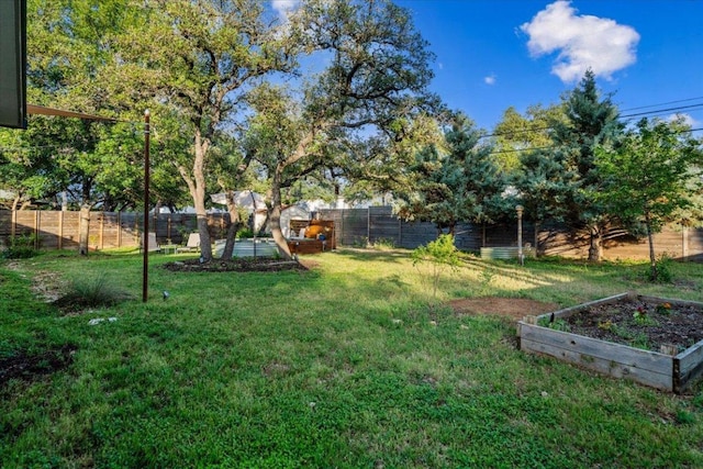 6905 Whispering Oaks Dr, Austin, TX 78745 - view of yard with a vegetable garden