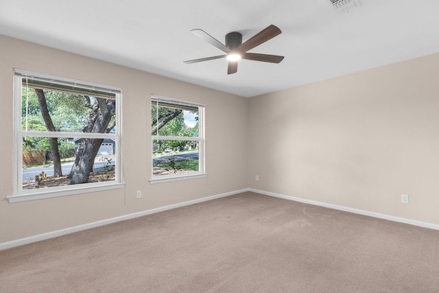 unfurnished room featuring ceiling fan, baseboards, and light carpet