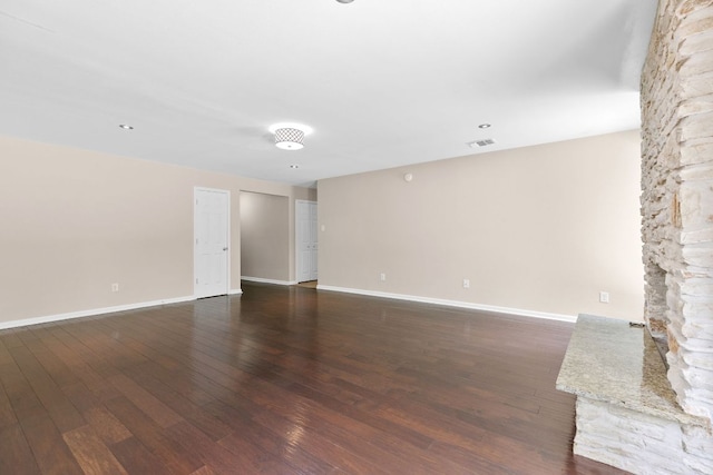 unfurnished living room with dark wood finished floors and baseboards