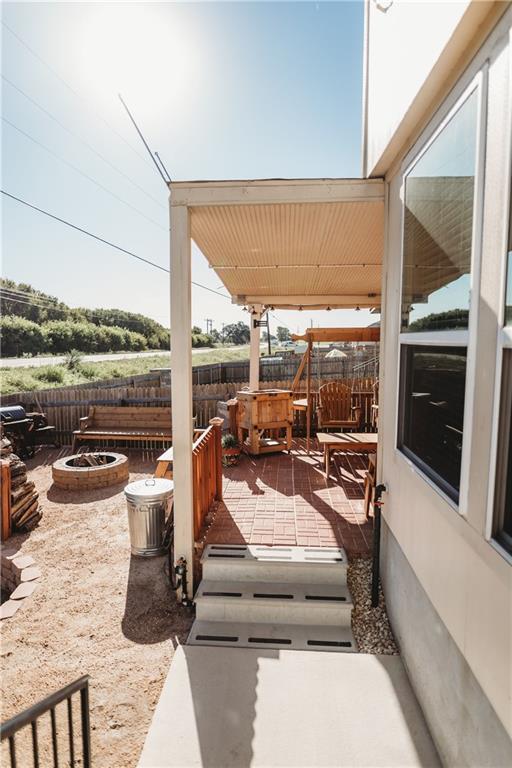 view of patio / terrace featuring an outdoor fire pit and a fenced backyard