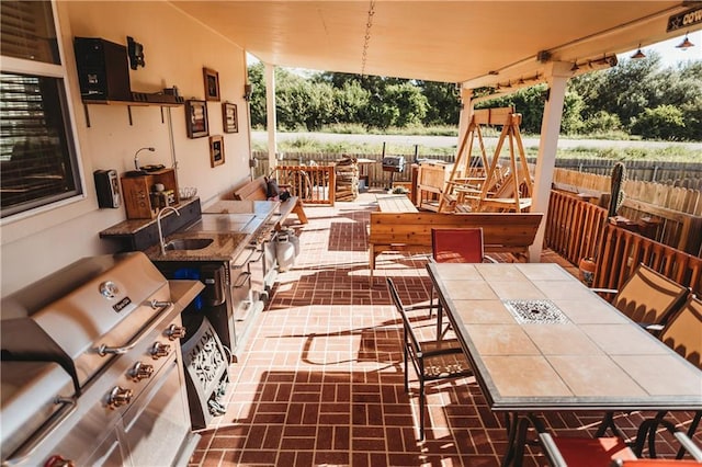 192 Falcon Dr, Luling, TX 78648 - view of patio with outdoor dining area, area for grilling, and a sink