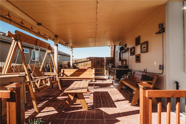 wooden deck featuring a patio and fence