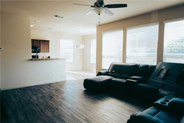 192 Falcon Dr, Luling, TX 78648 - living area with wood finished floors, ceiling fan, and baseboards