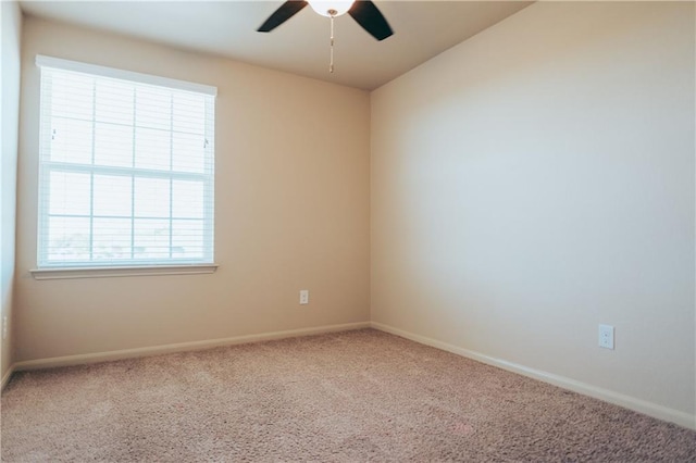 unfurnished room featuring carpet flooring, a ceiling fan, and baseboards