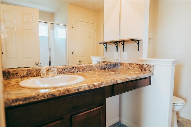 192 Falcon Dr, Luling, TX 78648 - bathroom featuring a shower stall, toilet, vanity, and baseboards