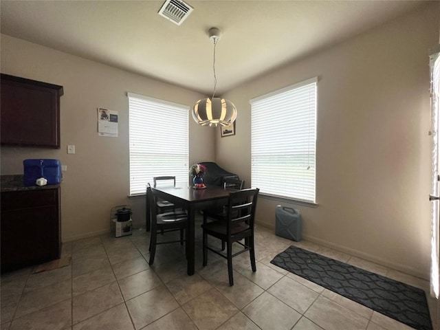 192 Falcon Dr, Luling, TX 78648 - dining space featuring light tile patterned floors, a chandelier, and baseboards