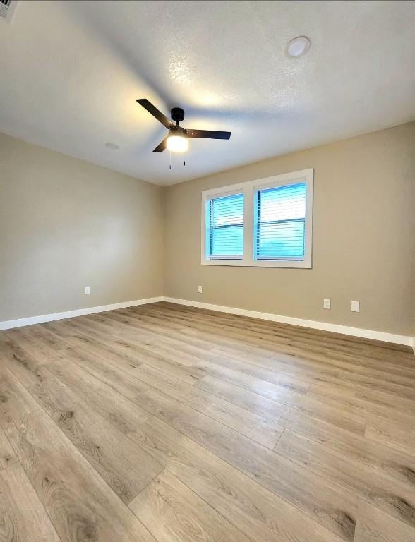 1011 N State Highway 95 N, Bastrop, TX 78602 - spare room with light wood-type flooring, baseboards, and a ceiling fan