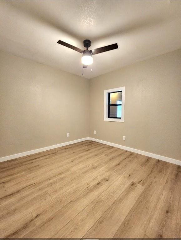 1011 N State Highway 95 N, Bastrop, TX 78602 - unfurnished room with wood finished floors, baseboards, and a ceiling fan