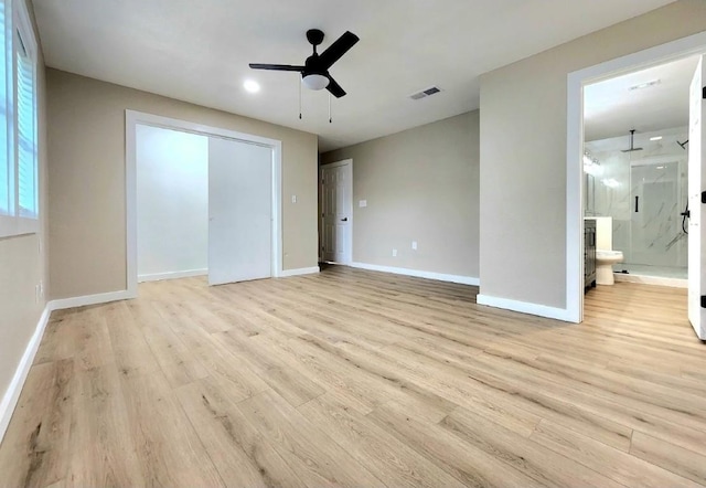 unfurnished bedroom with light wood-style flooring, baseboards, connected bathroom, and ceiling fan