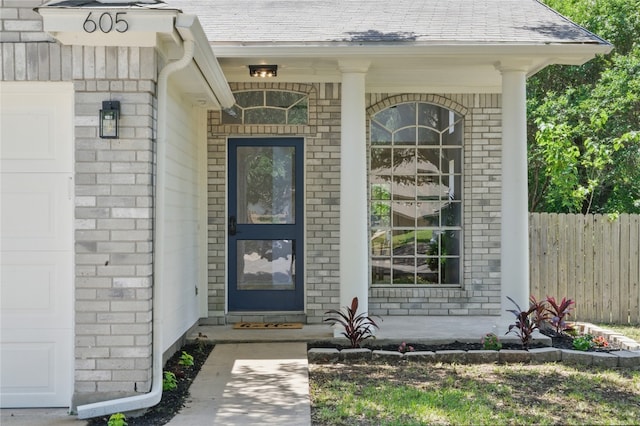605 Swanson Cv, Austin, TX 78748 - property entrance featuring brick siding, an attached garage, and covered porch