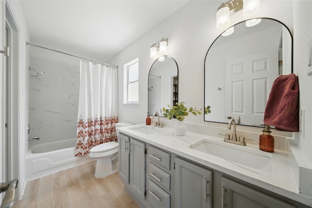 605 Swanson Cv, Austin, TX 78748 - full bathroom featuring double vanity, shower / tub combo with curtain, and wood finished floors