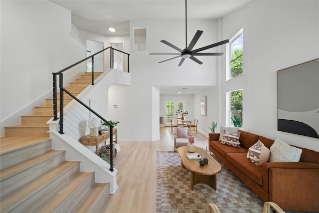 605 Swanson Cv, Austin, TX 78748 - living area featuring wood finished floors, a high ceiling, ceiling fan, stairway, and recessed lighting