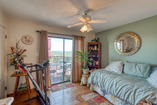 104 Derringer, Horseshoe Bay, TX 78657 - bedroom featuring access to outside, ceiling fan, and a textured ceiling