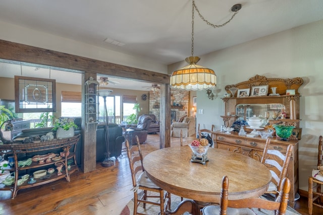 104 Derringer, Horseshoe Bay, TX 78657 - dining area with hardwood / wood-style floors, a ceiling fan, and a fireplace