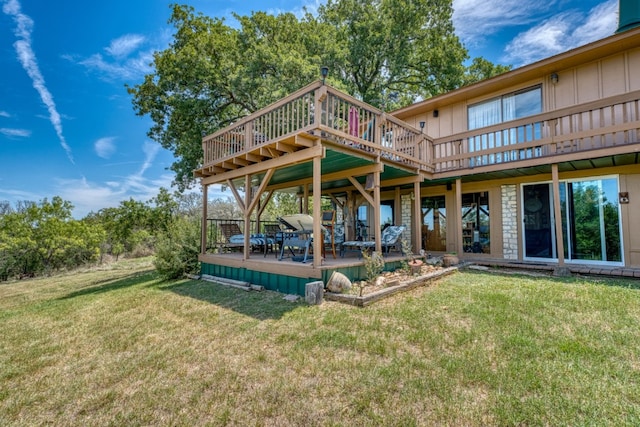 104 Derringer, Horseshoe Bay, TX 78657 - back of property with a wooden deck, a lawn, and board and batten siding
