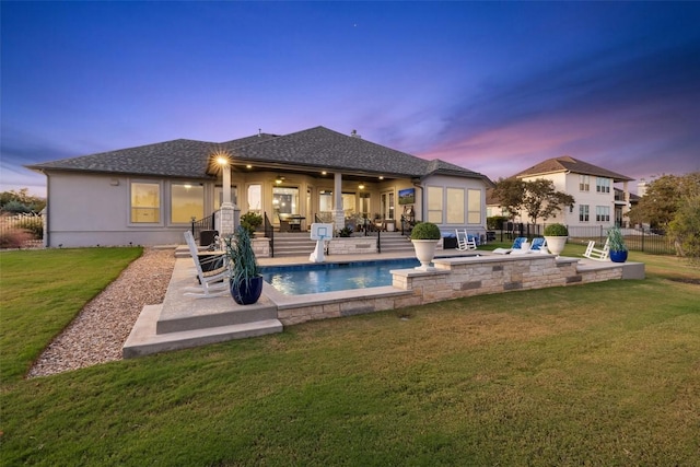 rear view of house featuring a patio, a shingled roof, and stucco siding